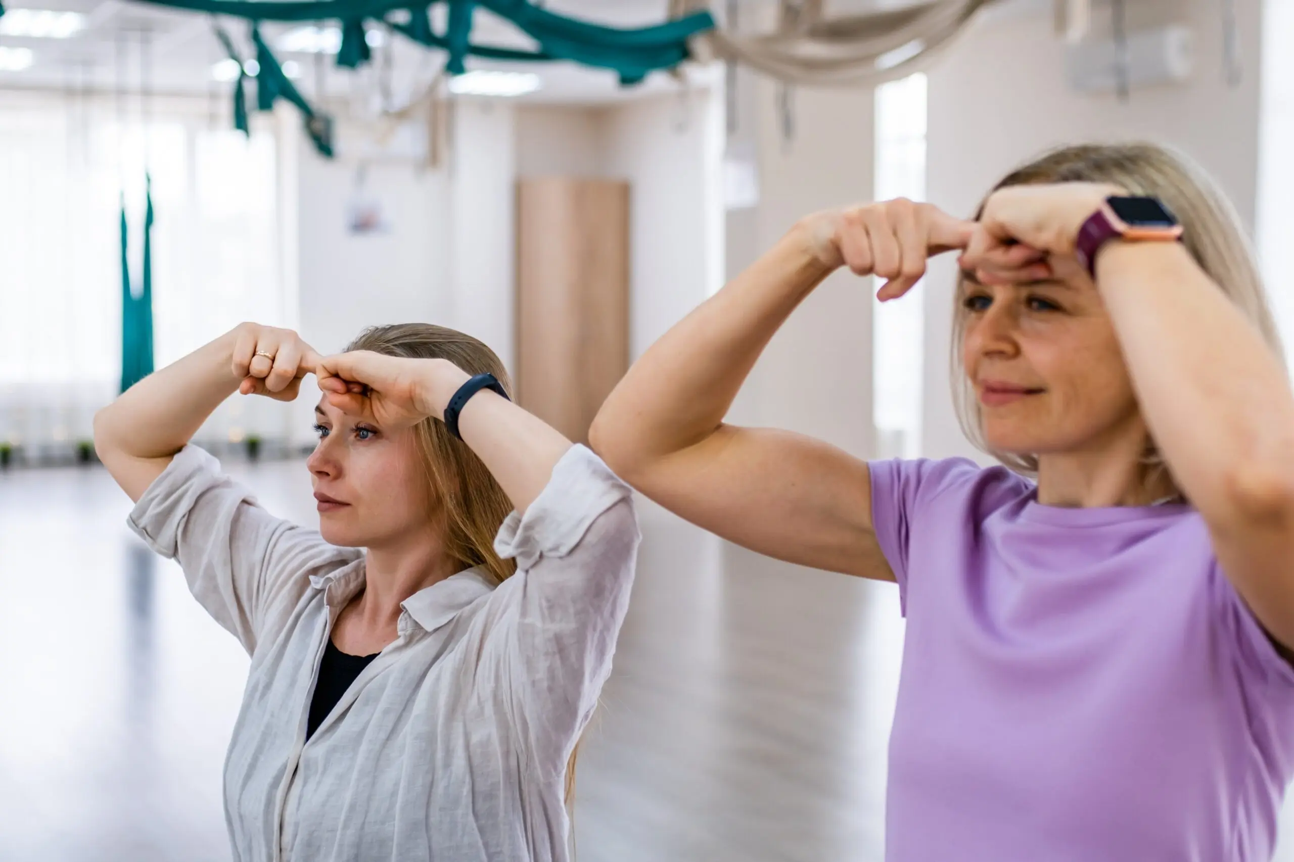 Women practicing face yoga exercises for holistic self-care